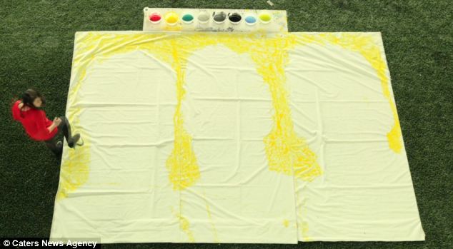 Yellow card: Ms Yi makes her feat appear effortless as she outlines the three players with a lemon hue